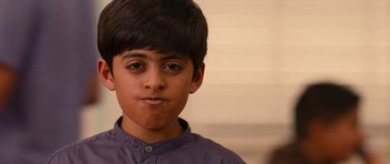 Movie still from “Diary of a Wimpy Kid: Rodrick Rules” (2011), directed by David Bowers – A young boy is looking at the camera; Close Up shot, Over the shoulder angle