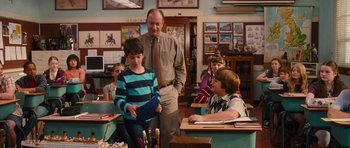 Movie still from “Diary of a Wimpy Kid: Rodrick Rules” (2011), directed by David Bowers – A group of people sitting in a room; Medium shot, Over the shoulder angle
