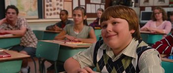 Movie still from “Diary of a Wimpy Kid: Rodrick Rules” (2011), directed by David Bowers – A group of children sitting at desks in a classroom; Close Up shot, Over the shoulder angle
