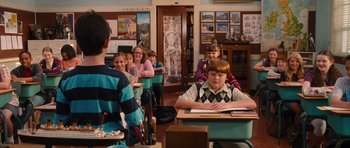 Movie still from “Diary of a Wimpy Kid: Rodrick Rules” (2011), directed by David Bowers – A group of children sitting at a table in a classroom; Wide shot, Over the shoulder angle