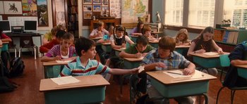 Movie still from “Diary of a Wimpy Kid: Rodrick Rules” (2011), directed by David Bowers – A group of children sitting at desks in a classroom; Medium shot, High angle