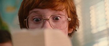 Movie still from “Diary of a Wimpy Kid: Rodrick Rules” (2011), directed by David Bowers – A person wearing glasses and looking surprised; Extreme Close Up shot, Low angle