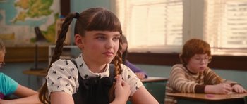 Movie still from “Diary of a Wimpy Kid: Rodrick Rules” (2011), directed by David Bowers – A young girl with a pigtail in front of a window; Close Up shot, Over the shoulder angle