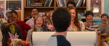 Movie still from “Diary of a Wimpy Kid: Rodrick Rules” (2011), directed by David Bowers – A group of children laughing and playing a game; Medium shot, Over the shoulder angle