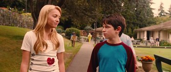 Movie still from “Diary of a Wimpy Kid: Rodrick Rules” (2011), directed by David Bowers – A boy and a girl walking on a sidewalk; Medium shot, Over the shoulder angle