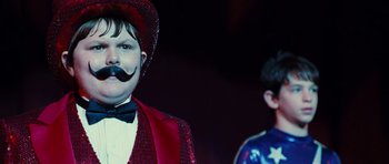 Movie still from “Diary of a Wimpy Kid: Rodrick Rules” (2011), directed by David Bowers – A man with a fake mustache standing next to a boy; Close Up shot, Over the shoulder angle