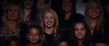 Movie still from “Diary of a Wimpy Kid: Rodrick Rules” (2011), directed by David Bowers – A group of young people sitting together in a theater; Medium shot, Over the shoulder angle
