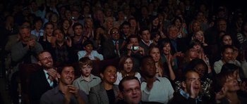 Movie still from “Diary of a Wimpy Kid: Rodrick Rules” (2011), directed by David Bowers – A group of people sitting in a room watching a show; Medium shot, High angle