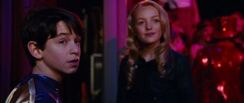 Movie still from “Diary of a Wimpy Kid: Rodrick Rules” (2011), directed by David Bowers – Two young women standing next to each other in a room; Close Up shot, Over the shoulder angle