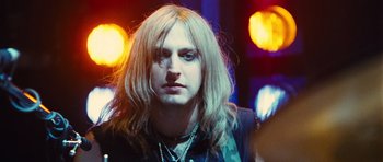 Movie still from “Diary of a Wimpy Kid: Rodrick Rules” (2011), directed by David Bowers – A person with long blonde hair; Close Up shot, Over the shoulder angle