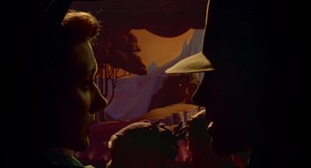 Movie still from “Dick Tracy” (1990), directed by Warren Beatty – A man and a woman looking at each other in the dark; Extreme Close Up shot, Low angle