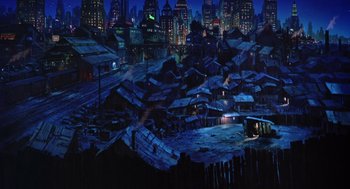 Movie still from “Dick Tracy” (1990), directed by Warren Beatty – A painting of a city at night with lights on buildings; Extreme Wide shot, High angle