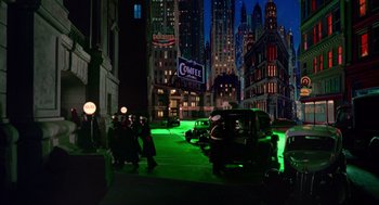 Movie still from “Dick Tracy” (1990), directed by Warren Beatty – A group of people standing on the side of a street; Extreme Wide shot, Low angle