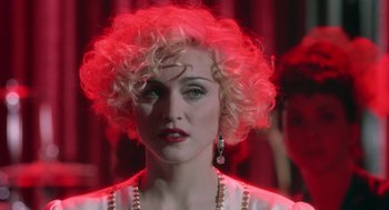 Movie still from “Dick Tracy” (1990), directed by Warren Beatty – A person with curly blonde hair; Close Up shot, Over the shoulder angle