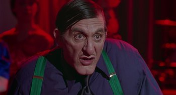 Movie still from “Dick Tracy” (1990), directed by Warren Beatty – A person wearing a shirt and a tie; Close Up shot, Low angle