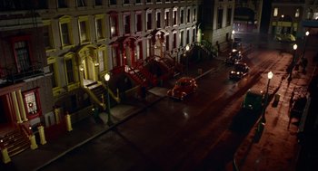 Movie still from “Dick Tracy” (1990), directed by Warren Beatty – A street scene with a fire hydrant and stairs; Extreme Wide shot, High angle