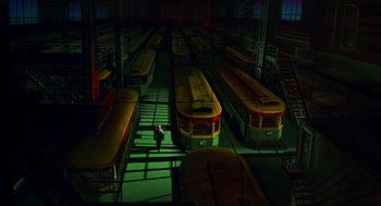 Movie still from “Dick Tracy” (1990), directed by Warren Beatty – Many trolleys parked in a warehouse; Extreme Wide shot, High angle