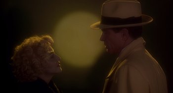 Movie still from “Dick Tracy” (1990), directed by Warren Beatty – A man and a woman are looking at one another; Close Up shot, Low angle