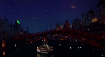 Movie still from “Dick Tracy” (1990), directed by Warren Beatty – A boat floating on a body of water at night; Extreme Wide shot, High angle