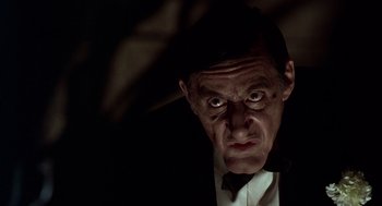 Movie still from “Dick Tracy” (1990), directed by Warren Beatty – A person wearing a suit and tie; Close Up shot, Low angle