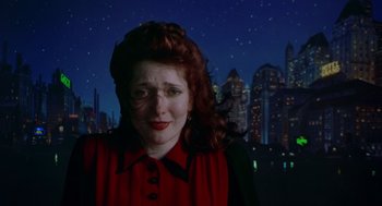 Movie still from “Dick Tracy” (1990), directed by Warren Beatty – A woman in a red shirt and black shirt; Close Up shot, Over the shoulder angle