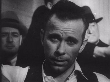 An old black and white photo of a man in a crowd