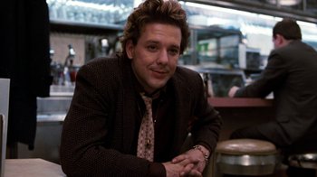Movie still from “Diner” (1982), directed by Barry Levinson – A man sitting at a table with his hands crossed; Close Up shot, Low angle