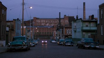 Movie still from “Diner” (1982), directed by Barry Levinson – Cars are driving down the street at night; Extreme Wide shot, High angle