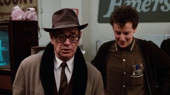 Movie still from “Diner” (1982), directed by Barry Levinson – A man wearing a hat and a tie next to another man wearing a hat; Medium shot, Over the shoulder angle