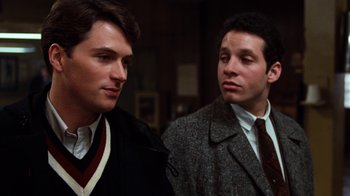 Movie still from “Diner” (1982), directed by Barry Levinson – A couple of men standing next to each other; Close Up shot, Over the shoulder angle
