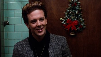 Movie still from “Diner” (1982), directed by Barry Levinson – A man in a suit smiling for the camera; Close Up shot, Over the shoulder angle