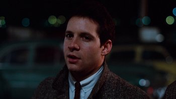 Movie still from “Diner” (1982), directed by Barry Levinson – A person wearing a suit and tie; Close Up shot, Over the shoulder angle