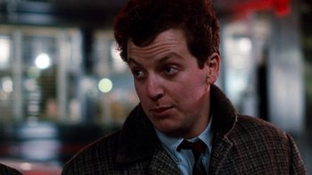 Movie still from “Diner” (1982), directed by Barry Levinson – A person wearing a suit and tie; Close Up shot, Low angle