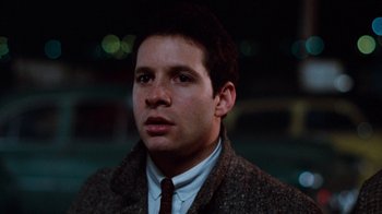 Movie still from “Diner” (1982), directed by Barry Levinson – A person wearing a suit and tie; Close Up shot, Low angle