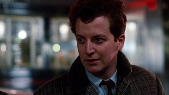 Movie still from “Diner” (1982), directed by Barry Levinson – A person wearing a suit and tie; Close Up shot, Low angle