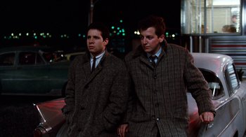 Movie still from “Diner” (1982), directed by Barry Levinson – A couple of men standing next to each other on the street; Medium shot, Low angle