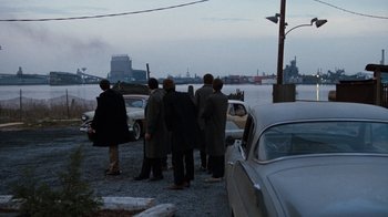 Movie still from “Diner” (1982), directed by Barry Levinson – A group of people standing next to a body of water; Extreme Wide shot, High angle