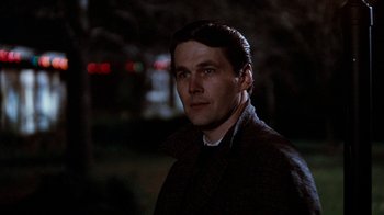 Movie still from “Diner” (1982), directed by Barry Levinson – A man in a brown coat standing in the dark; Close Up shot, Low angle