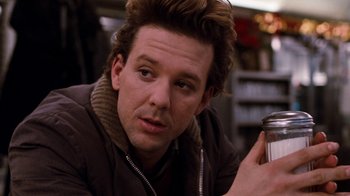 Movie still from “Diner” (1982), directed by Barry Levinson – A person holding a cup of coffee; Close Up shot, Over the shoulder angle