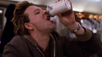 Movie still from “Diner” (1982), directed by Barry Levinson – A person drinking a can of beer; Close Up shot, Low angle
