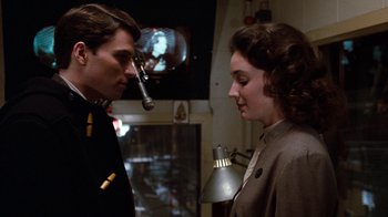 Movie still from “Diner” (1982), directed by Barry Levinson – A man and a woman standing next to each other in a room; Close Up shot, Over the shoulder angle