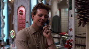 Movie still from “Diner” (1982), directed by Barry Levinson – A man talking on a phone while sitting in a room; Close Up shot, Low angle