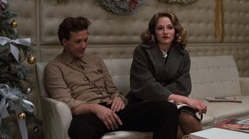 Movie still from “Diner” (1982), directed by Barry Levinson – A man and a woman sitting on a couch in a room; Medium shot, Low angle