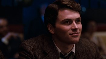 Movie still from “Diner” (1982), directed by Barry Levinson – A man in a brown jacket looking to his left; Close Up shot, Over the shoulder angle