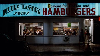 Movie still from “Diner” (1982), directed by Barry Levinson – A group of diners eating at a hamburger restaurant; Wide shot, High angle