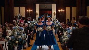 Movie still from “Diner” (1982), directed by Barry Levinson – A group of women in blue dresses holding bouquets of flowers; Wide shot, Over the shoulder angle