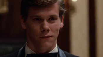 Movie still from “Diner” (1982), directed by Barry Levinson – A young man in a suit and bow tie; Close Up shot, Over the shoulder angle