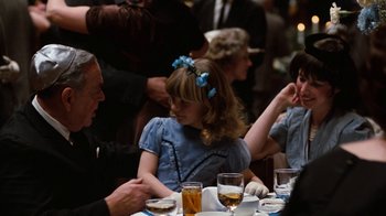 Movie still from “Diner” (1982), directed by Barry Levinson – A group of people sitting at a table with drinks; Medium shot, Over the shoulder angle