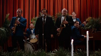 Movie still from “Diner” (1982), directed by Barry Levinson – A group of men in suits and bow ties playing instruments; Wide shot, Low angle