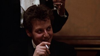 Movie still from “Diner” (1982), directed by Barry Levinson – A man in a suit and tie holding a cigarette; Close Up shot, Low angle